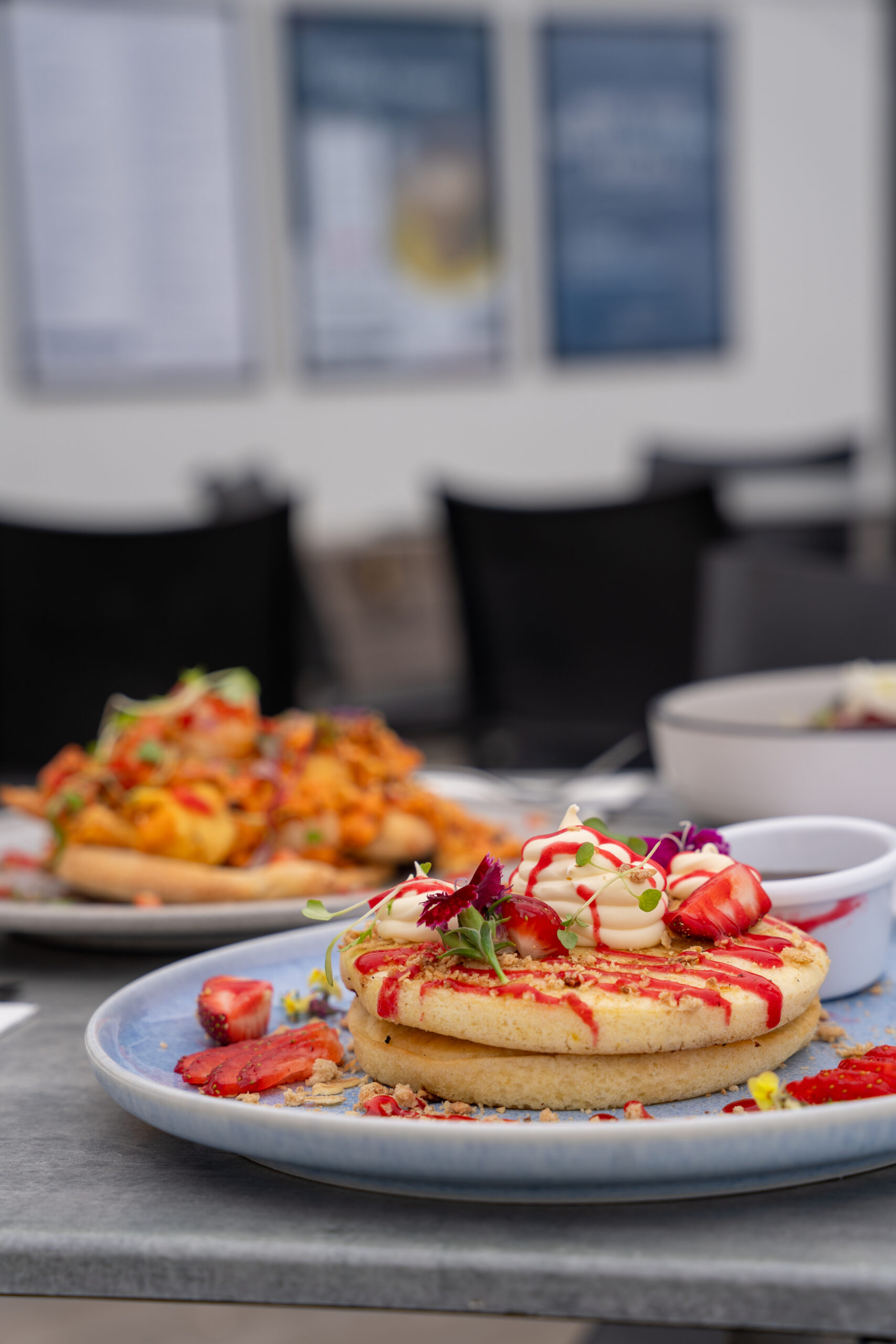 Fluffy lemon ricotta pancakes served with fresh berries at Sandbar Beach Café