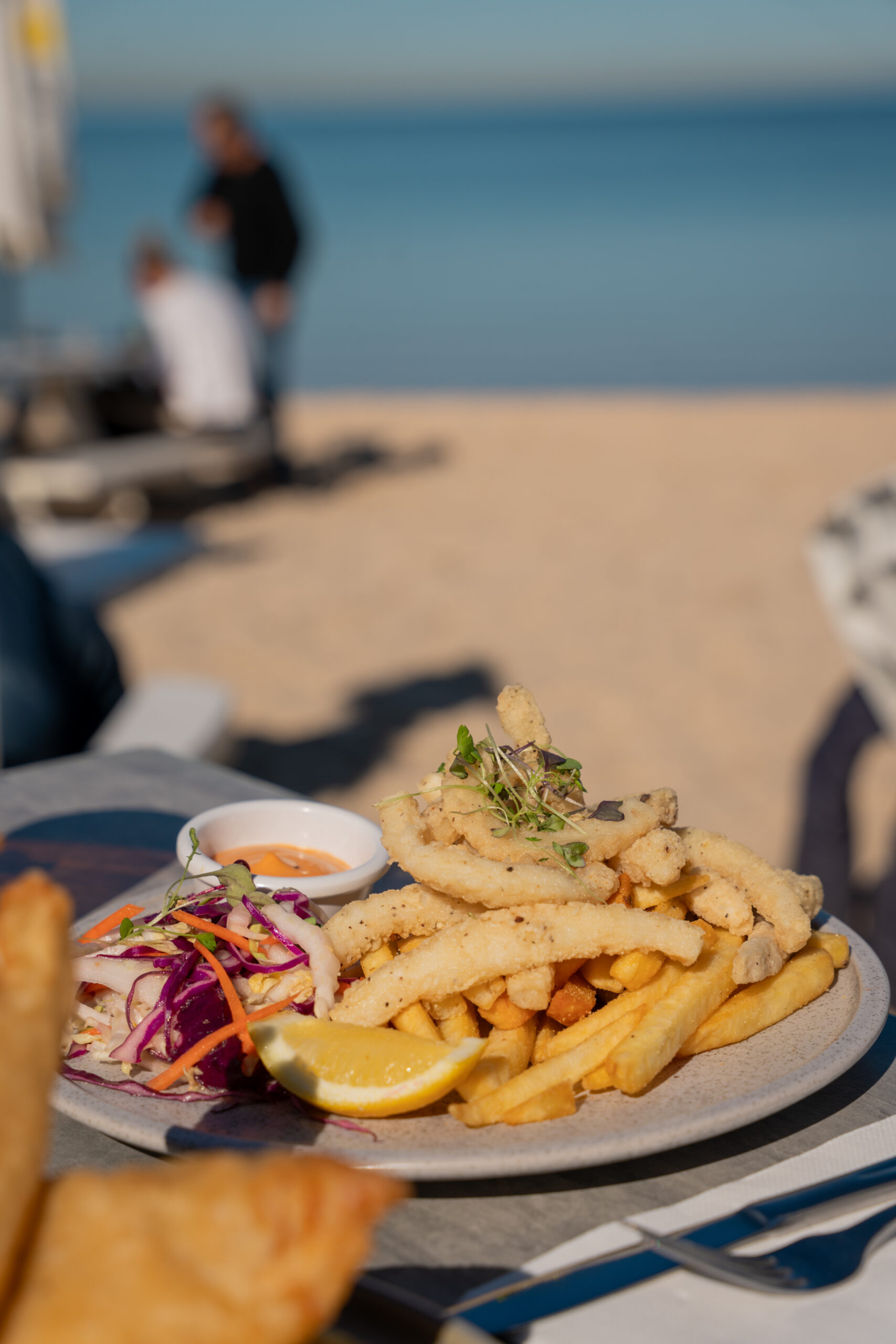 Crispy fried lemon and pepper calamari served with rainbow slaw, golden chips, chipotle mayo, and a lemon wedge.