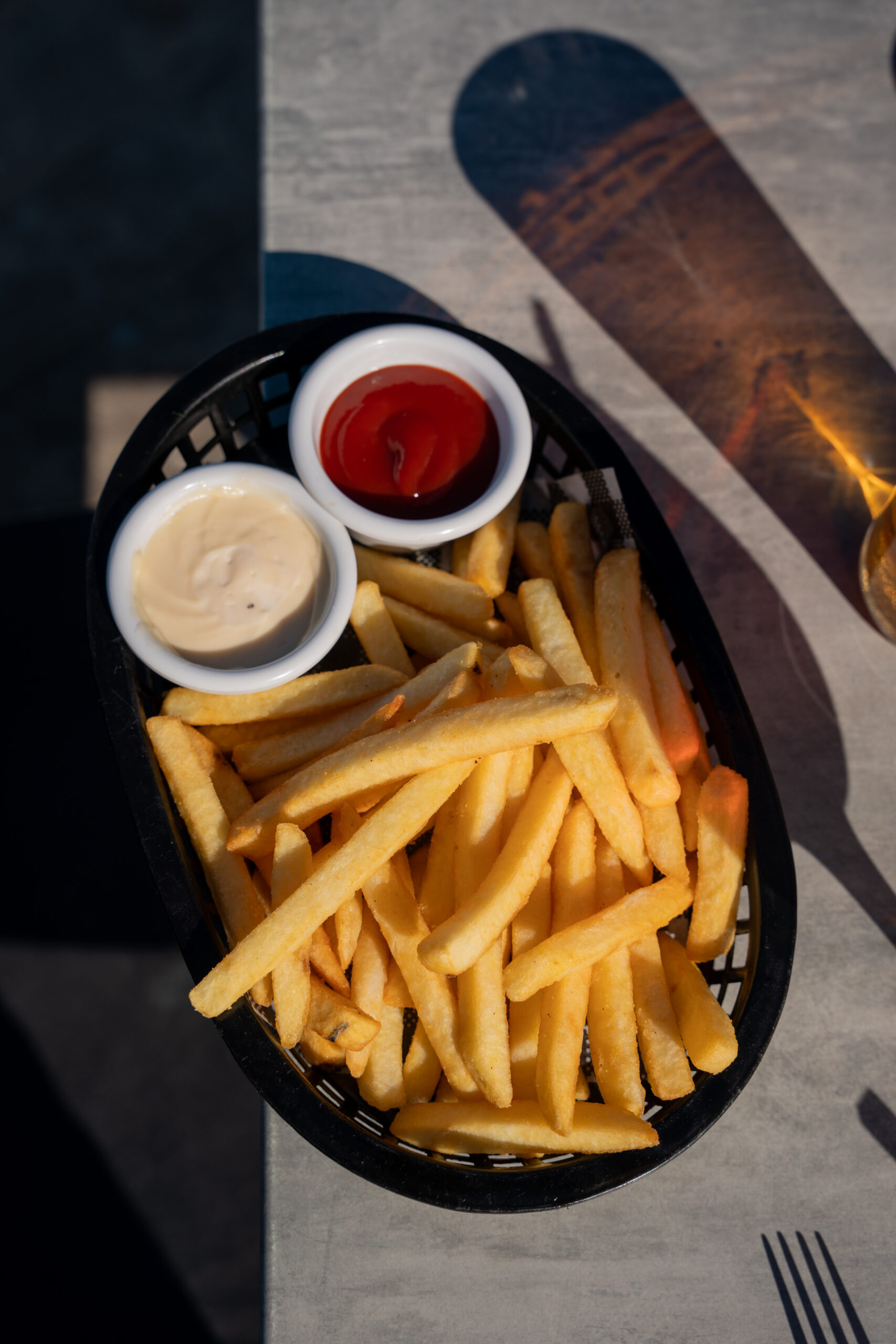Crispy fries with garlic mayonnaise and tomato ketchup on the side.