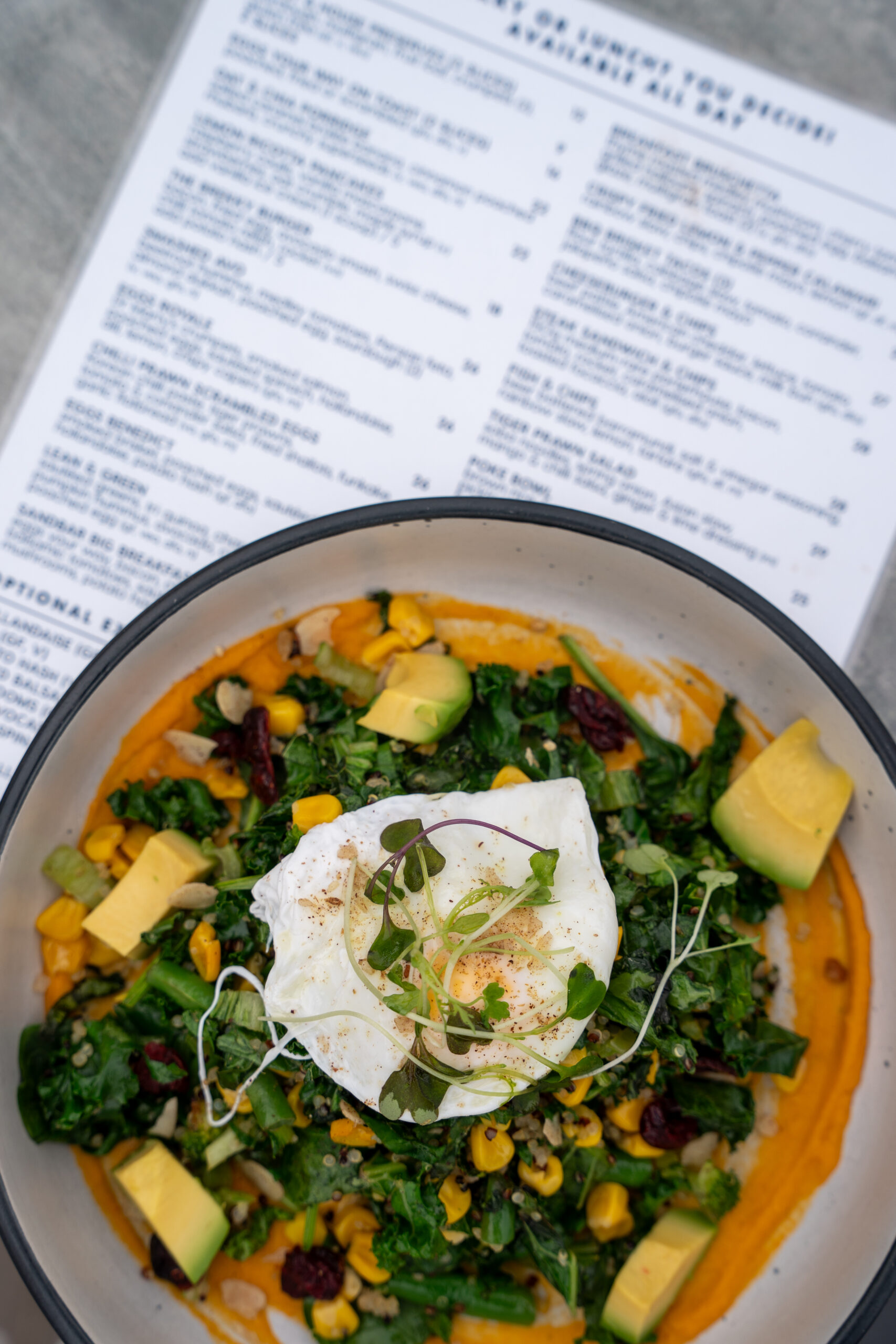 Lean & Green breakfast bowl with avocado, greens, and poached eggs at Sandbar Beach Café