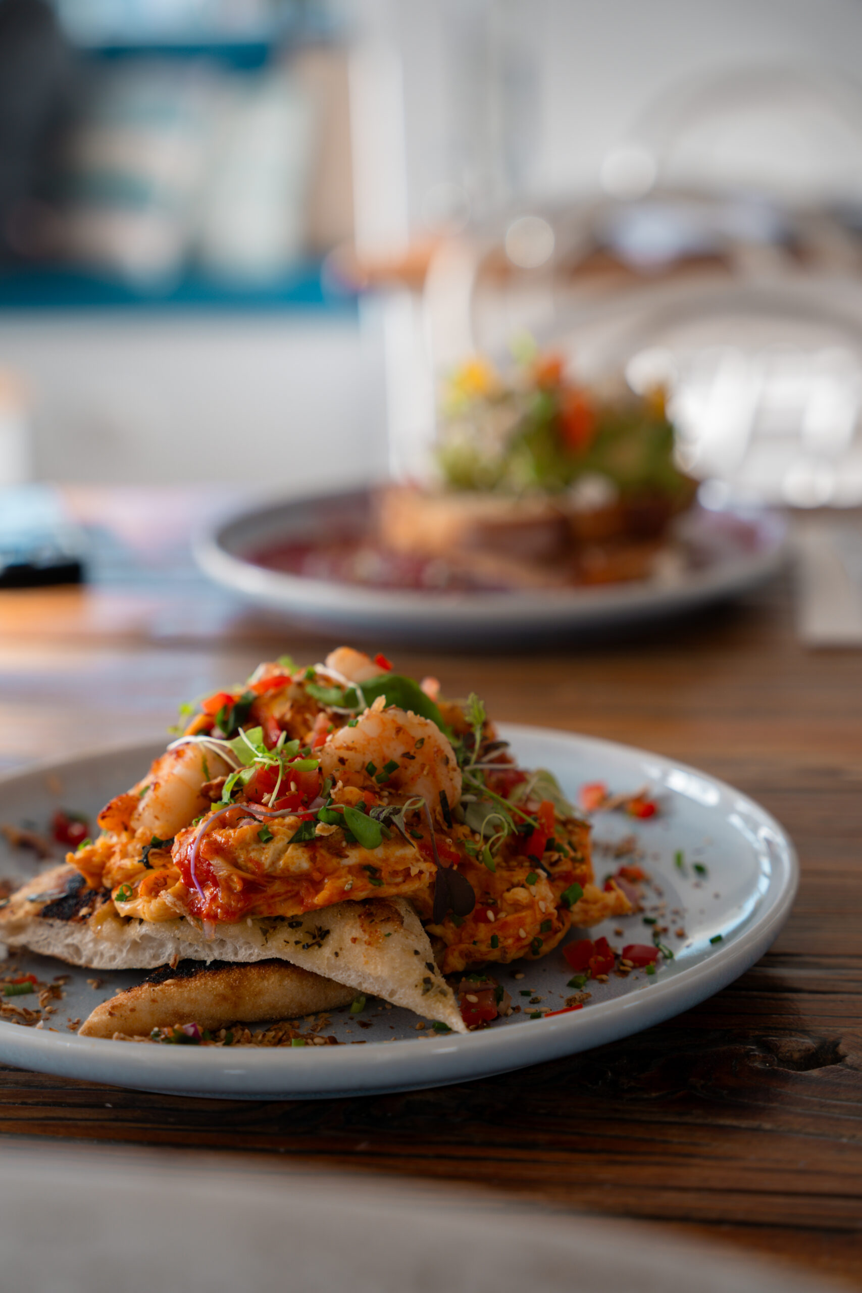 Scrambled eggs with chilli prawns and herbs for a spicy breakfast